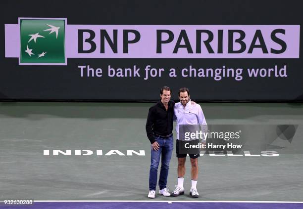 Tommy Haas of Germany poses for a photo with Roger Federer of Switzerland after announcing his retirement during the BNP Paribas Open at the Indian...