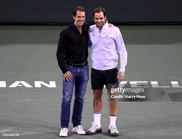 Tommy Haas of Germany poses for a photo with Roger Federer of Switzerland after announcing his retirement during the BNP Paribas Open at the Indian...