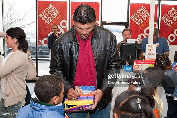 Anthony Munoz signs autographs for children on the boxes of their new shoes at Payless ShoeSource on November 20, 2009 in Cincinnati, Ohio.