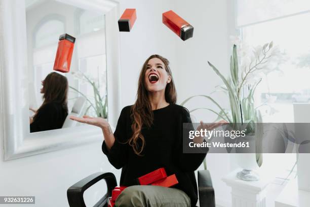 excited young woman juggling with cosmetics in beauty salon - woman juggling stock pictures, royalty-free photos & images