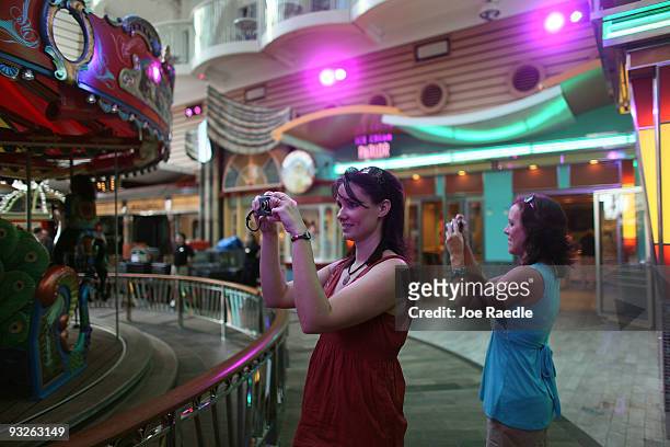 Kimberly Kane and Rachel Kessinger take photographs as they admire the cruise ship Oasis of the Seas on November 20, 2009 in Port Everglades,...