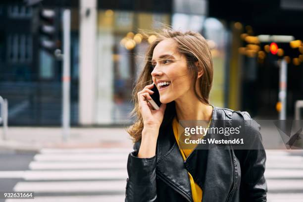 laughing woman on the phone - woman jacket stock pictures, royalty-free photos & images