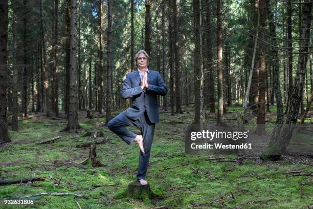 businessman practicing yoga in forest - bare feet male tree stock pictures, royalty-free photos & images