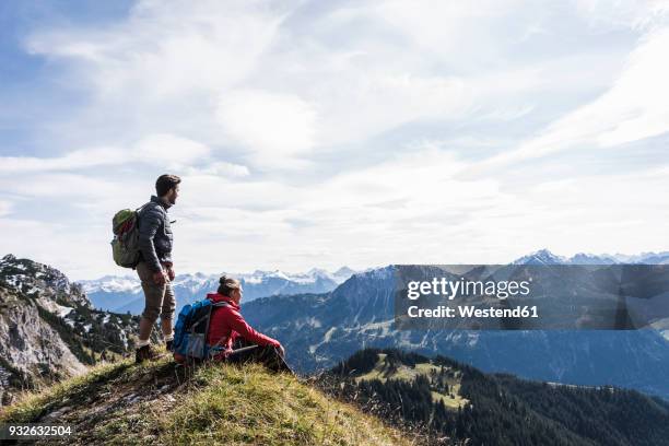 austria, tyrol, young couple in mountainscape looking at view - man on top of mountain stock pictures, royalty-free photos & images