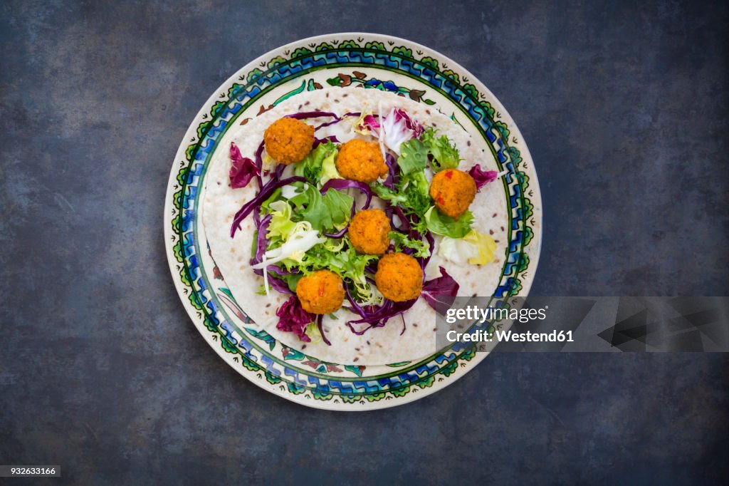 Falafel, wrap, salad, red and white cabbage, yogurt sauce with mint