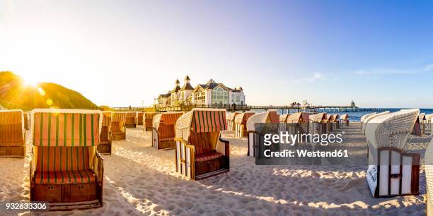 germany, mecklenburg-western pomerania, ruegen, sellin, sea bridge and hooded beach chairs - beach shelter ストックフォトと画像