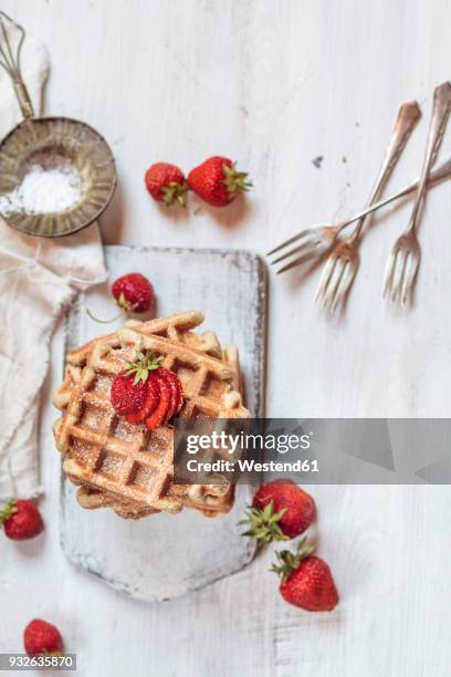 belgian waffles with strawberries and powdered sugar - belgium waffles stock pictures, royalty-free photos & images