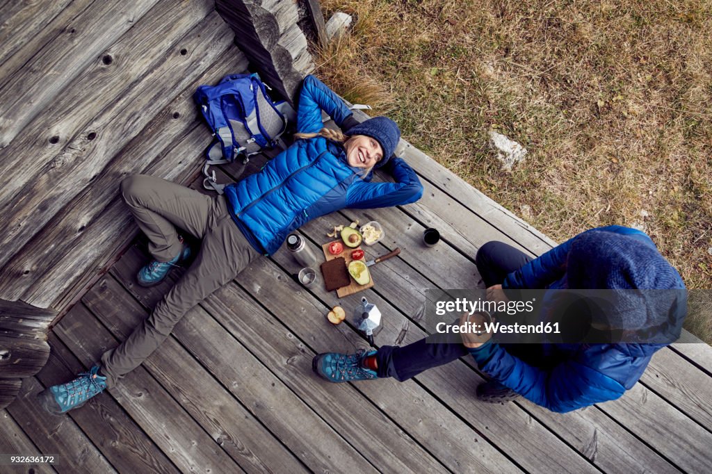 Overhead view of couple hikers having a break at mountain hut