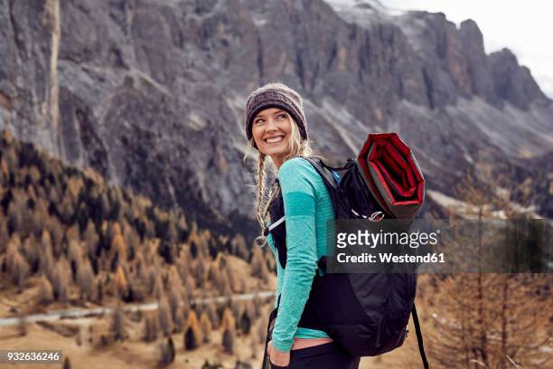 portrait of happy young woman hiking in the mountains - hiking backpack stock pictures, royalty-free photos & images