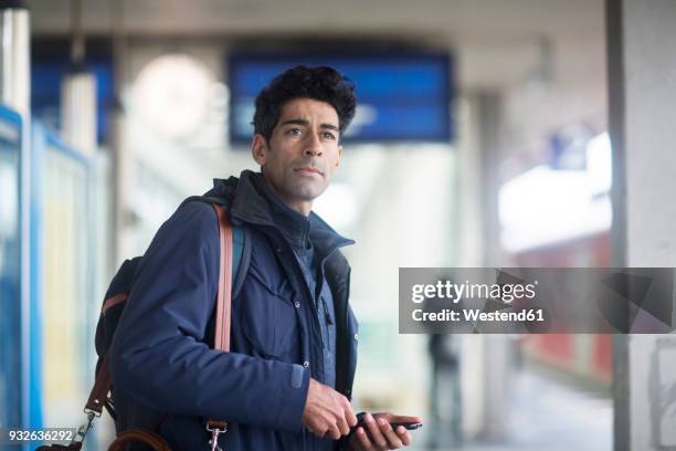 portrait of man waiting on platform - waiting stock-fotos und bilder