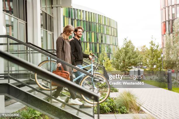 smiling couple leaving house with bicycles - house for sale fotografías e imágenes de stock