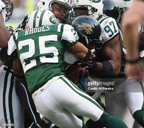 Linebacker Calvin Pace, Defensive End Mike DeVito and Safety Kerry Rhodes of the New York Jets stops Running Back Maurince Jones-Drew of the...