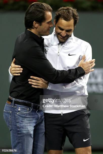 Tommy Haas is congratulated by Roger Federer after officially announcing his retirement at a ceremony after the Roger Federer quarterfnal match...