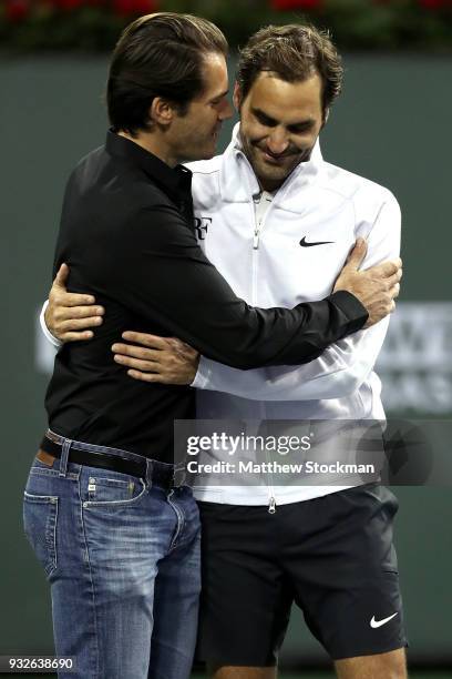 Tommy Haas is congratulated by Roger Federer after officially announcing his retirement at a ceremony after the Roger Federer quarterfnal match...