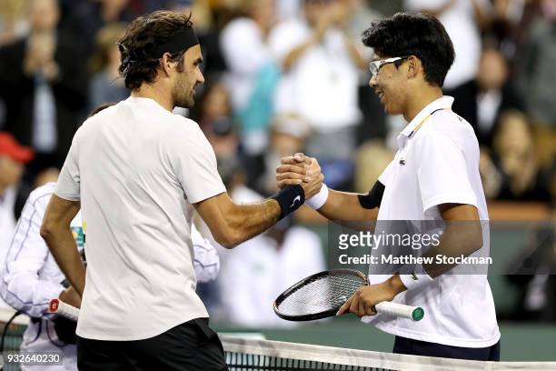 Roger Federer of Switzerland is congratulated by Hyeon Chung of Korea after their match during of the BNP Paribas Open at the Indian Wells Tennis...