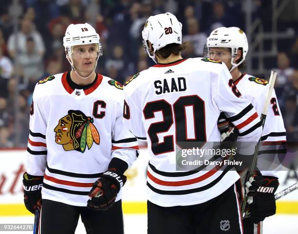 Jonathan Toews and Brandon Saad of the Chicago Blackhawks discuss strategy during a third period stoppage of play against the Winnipeg Jets at the...
