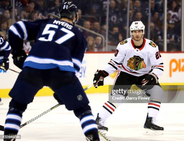 Brandon Saad of the Chicago Blackhawks keeps an eye on Tyler Myers of the Winnipeg Jets during third period action at the Bell MTS Place on March 15,...