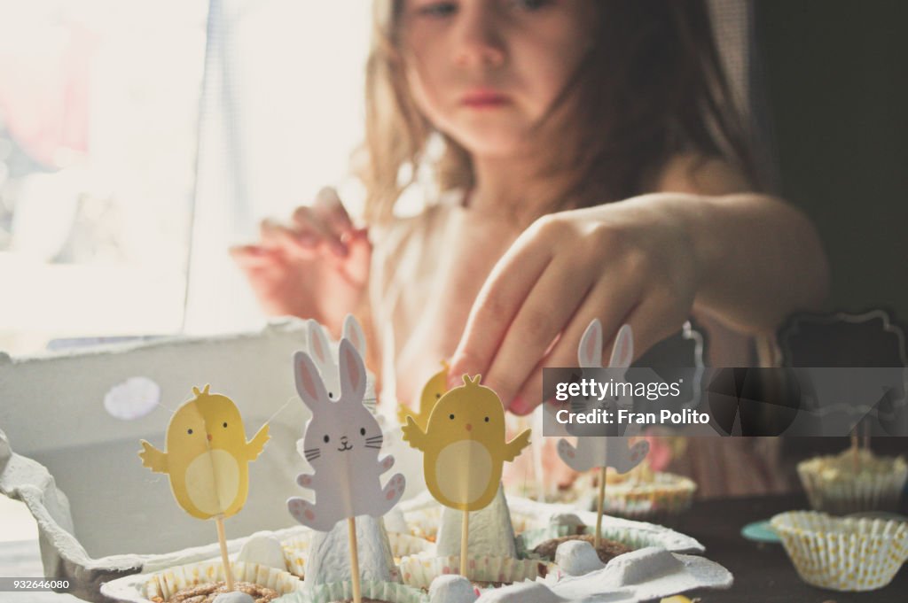 A girl making Easter muffins.