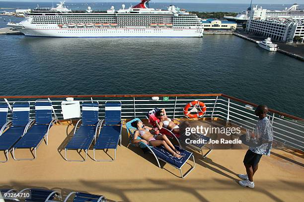 Savannah Vitello and Stephanie Dorazio take in the sun on board the cruise ship Oasis of the Seas on November 20, 2009 in Port Everglades, Florida....