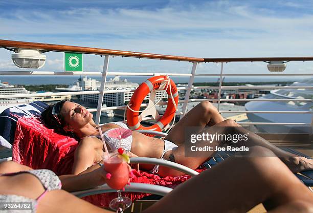Savannah Vitello and Stephanie Dorazio take in the sun on board the cruise ship Oasis of the Seas on November 20, 2009 in Port Everglades, Florida....