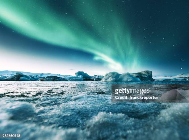 aurora borealis in iceland at jakulsarlon - beauty in nature stock pictures, royalty-free photos & images