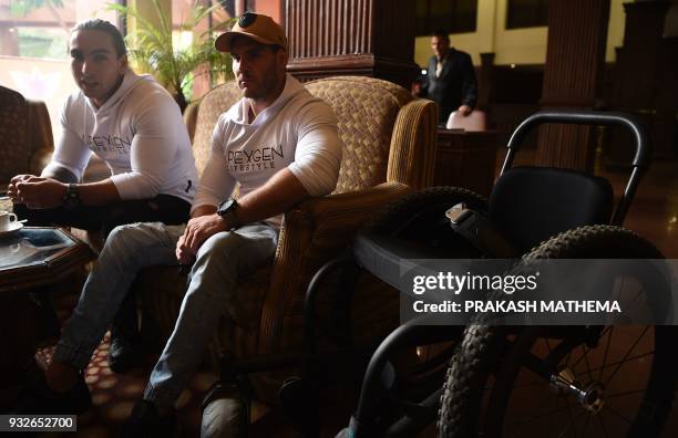 In this picture taken on March 15, 2018 wheelchair-bound Australian Scott Doolan and Matt Laycock take part in an interview with AFP in Kathmandu. A...