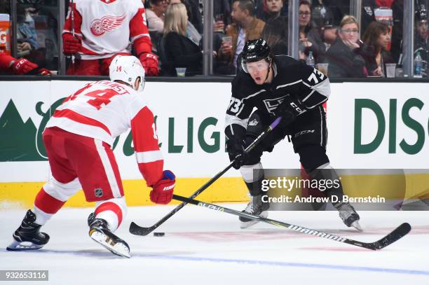 Tyler Toffoli of the Los Angeles Kings handles the puck against Gustav Nyquist of the Detroit Red Wings at STAPLES Center on March 15, 2018 in Los...