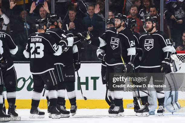 Derek Forbort and Jake Muzzin of the Los Angeles Kings high-five after a victory over the Detroit Red Wings at STAPLES Center on March 15, 2018 in...