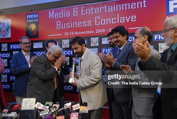 Kamal Hassan receives a souvenir at the FICCI Media and Entertainment Business Conclave in Chennai on Thursday, November 19, 2009.