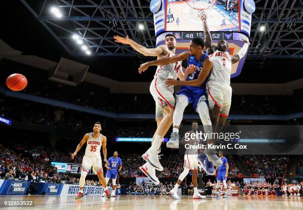 Massinburg of the Buffalo Bulls passes the ball in the second half against Dusan Ristic and Rawle Alkins of the Arizona Wildcats during the first...