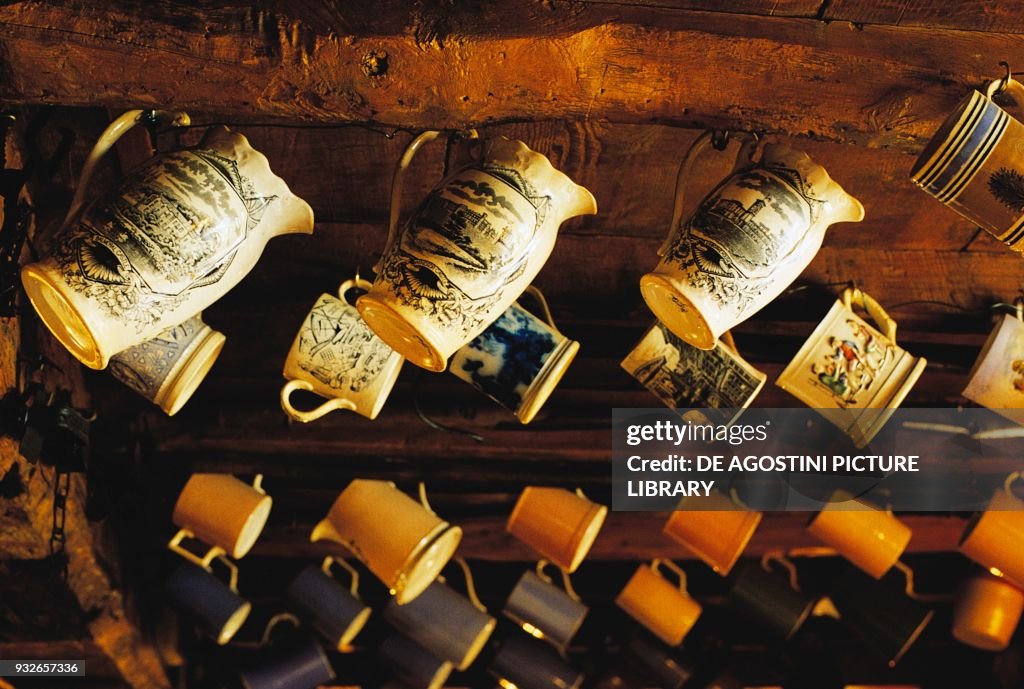 Jugs, tankards hanging in pub, Great Tew, Oxford