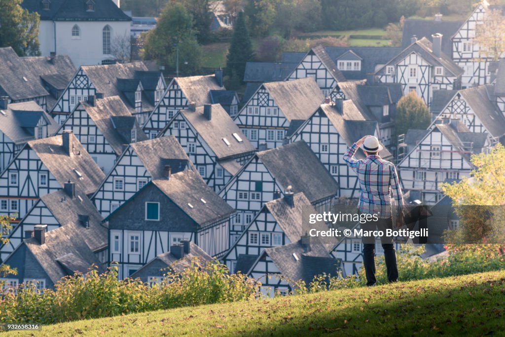 Tourist looking at the timber-framed houses of Freudenberg, Germany.