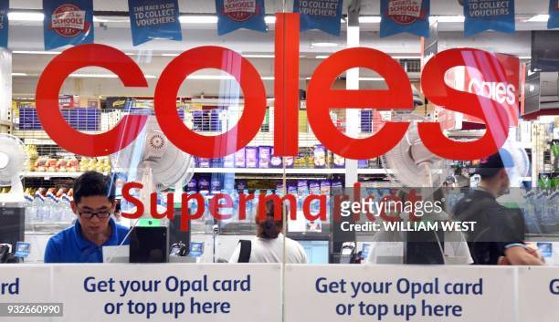 People are shopping at a Coles supermarket in the central business district of Sydney on March 16, 2018. Australian supermarket chain Coles will be...