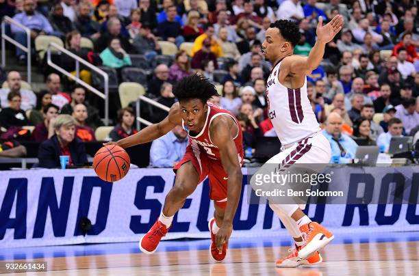 Collin Sexton of the Alabama Crimson Tide drives to the basket against Justin Robinson of the Virginia Tech Hokies in the first half during the first...