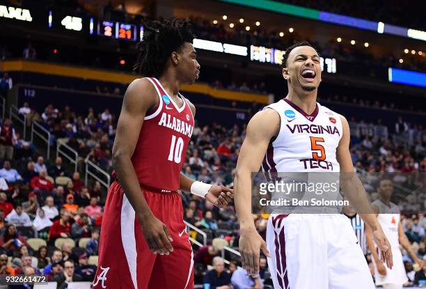 Justin Robinson of the Virginia Tech Hokies reacts after a basket in the second half during the game against the Alabama Crimson Tide in the first...