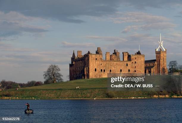 Ruins of Linlithgow Palace, Scottish monarch's residence dating to 15th century, St Michael's Church on the right, Scotland, United Kingdom.