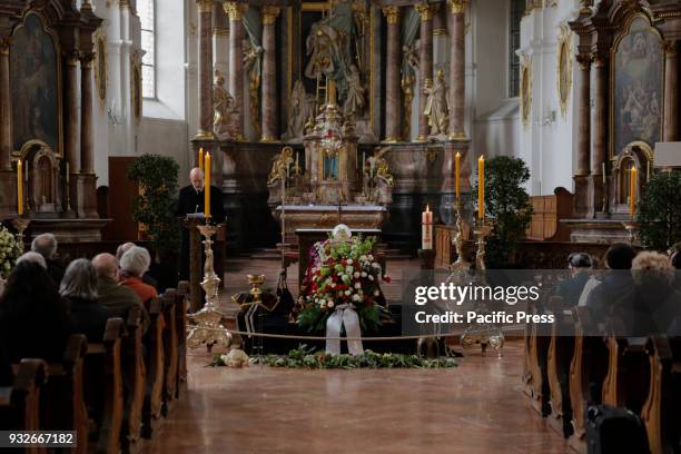 The body Cardinal Karl Lehmann lies in front of the altar on a catafalque, wearing his Pontifical vestments that consists of a violet chasuble, his...