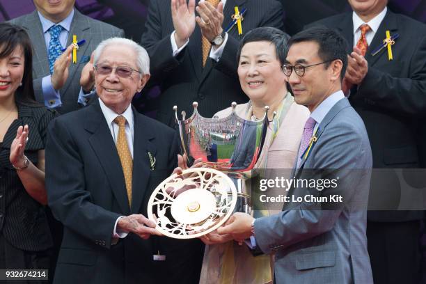 Mr Michael T H Lee, a Steward of the HKJC, presents the Queen's Silver Jubilee Cup gold-plated dishes to Dr & Mrs Cornel Li Fook Kwan, Owner of Able...