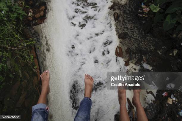 The flow of tributaries covered with textile waste is seen in Sukamaju Village, Majalaya, Bandung, West Java, Indonesia, on March 15, 2018. About 500...