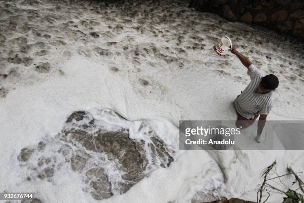 Resident tests the water content of Ph on a tributary stream filled with textile waste in Sukamaju Village, Majalaya, Bandung, West Java, Indonesia,...