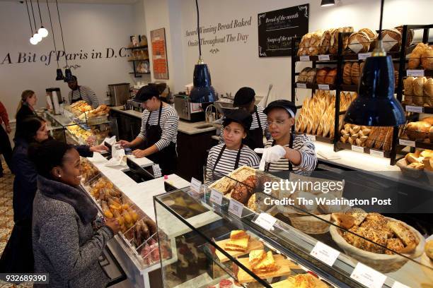 Right to left: Ashley Cannon and Ari Adams wait on customers at the bread and pastry counter during lunch at Maison Kayser's F St. Location...