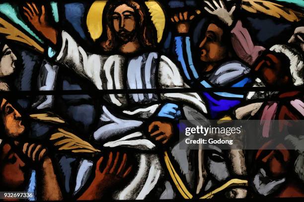 Saint-Joseph church. Stained glass window. Palm sunday. The entry of Jesus in Jerusalem. Geneva. Switzerland.