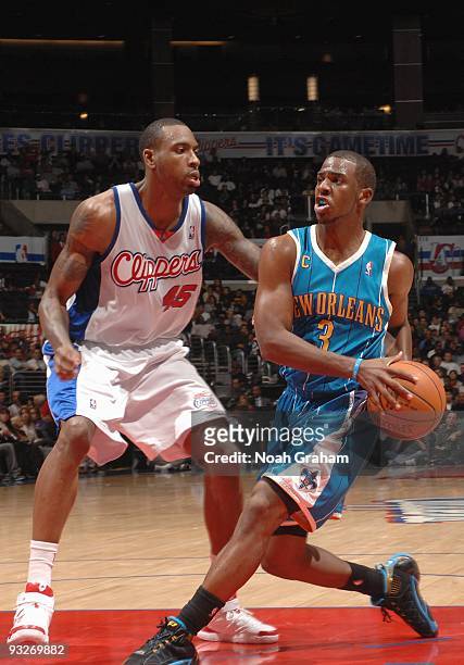 Chris Paul of the New Orleans Hornets drives down the lane against Rasual Butler of the Los Angeles Clippers during the game at Staples Center on...