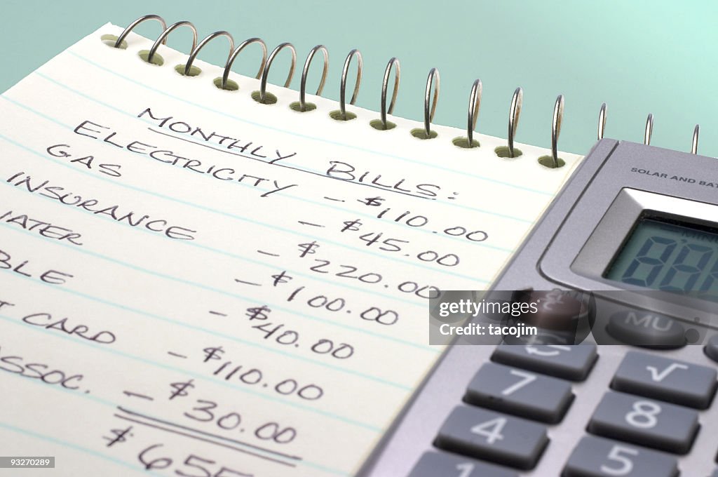 Summation of monthly bills on a notepad by a calculator