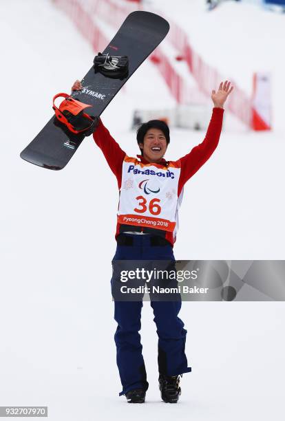 Gurimu Narita of Japan celebrates during the victory ceremony after winning the Gold medal for the Men's Banked Slalom SB-LL2 Snowboard during day...
