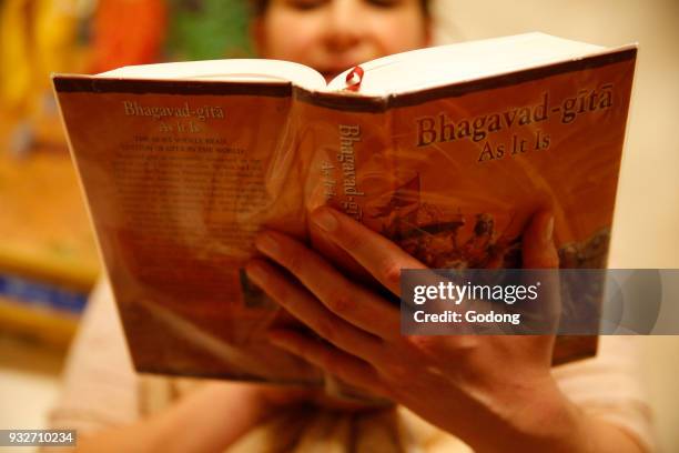 Gita Jayanti celebration in an ISKCON temple. Devotee reading the Bhagavad Gita. Sarcelles. France.