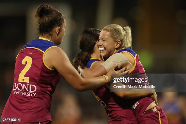 Sophie Conway of the Lions celebrates with team mates after kicking a goal during the round seven AFLW match between the Greater Western Sydney...