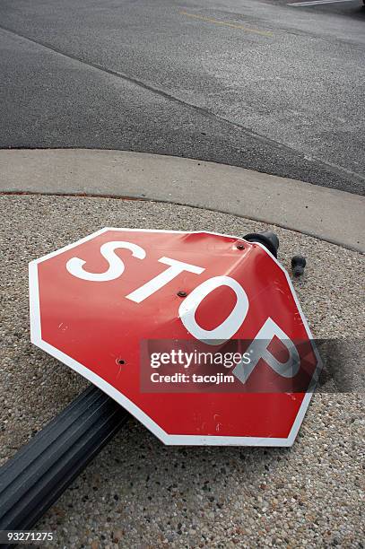 stop sign lying in the street as the result of an accident - bendy stock pictures, royalty-free photos & images