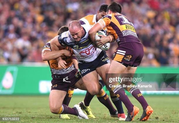 Matthew Scott of the Cowboys takes on the defence during the round two NRL match between the Brisbane Broncos and the North Queensland Cowboys at...