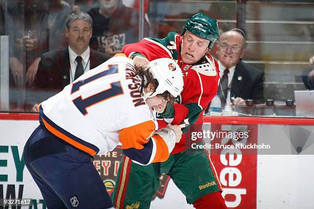 Nathan Smith of the Minnesota Wild fights with Nate Thompson of the New York Islanders during the game at the Xcel Energy Center on November 20, 2009...